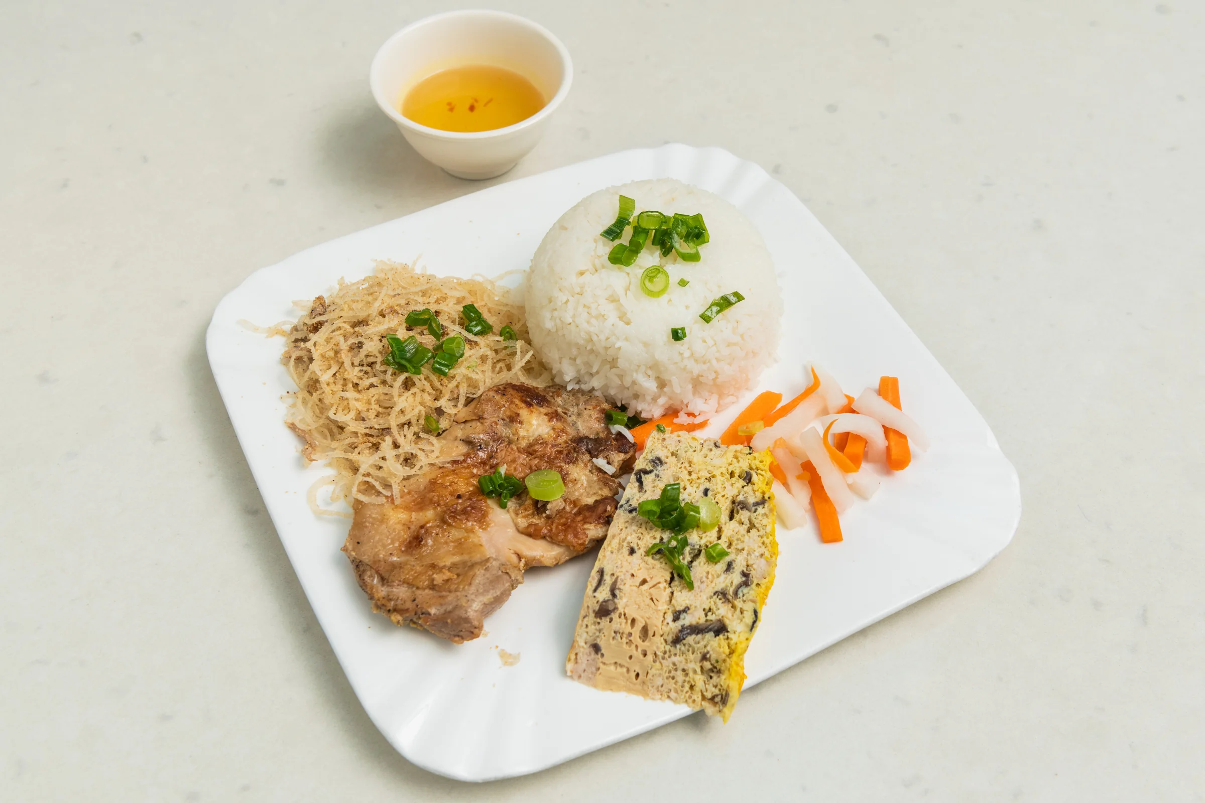 Pho Xe Lua BBQ chicken rice plate with shredded pork skin and steamed egg